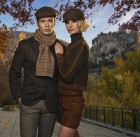 Elegant couple in caps against autumnal landscape