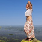 Girl on the beach in a long skirt
