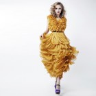 Lovely woman blonde fashion model in yellow dress posing