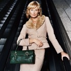 Portrait of a Young, Well Dressed Woman Standing on an Escalator