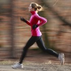 Young woman running outdoors in a city park
