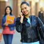 woman on phone wearing leather jacket