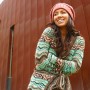 A beautiful natural looking model poses in a crocheted sweater